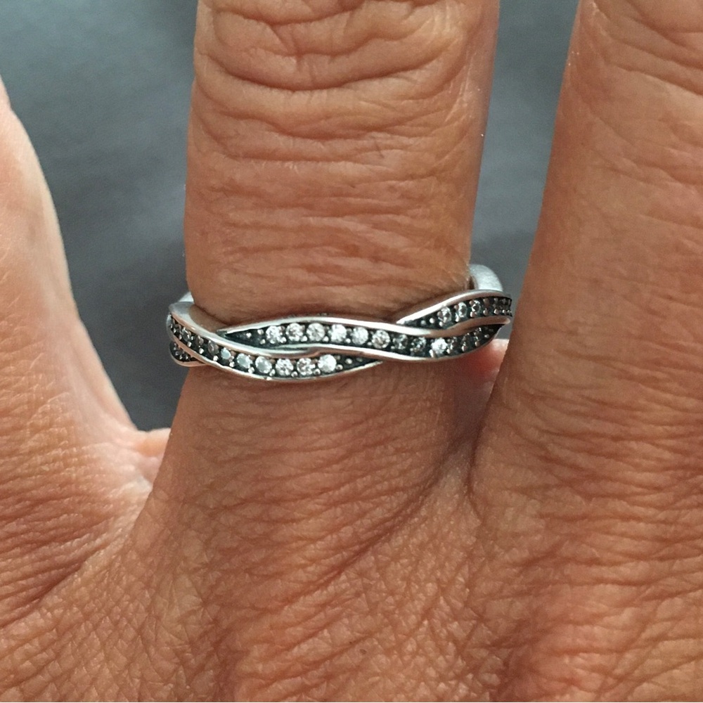 Excellent condition pandora silver ring with twisting cubic zirconia stones.